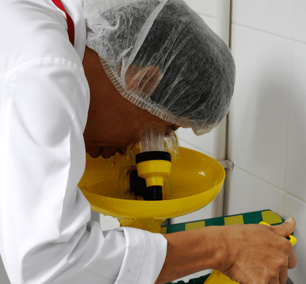 Worker rinsing eyes at safety station
