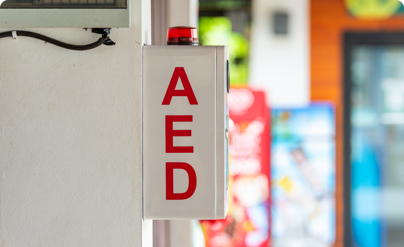 AED wall-mounted box with red letters